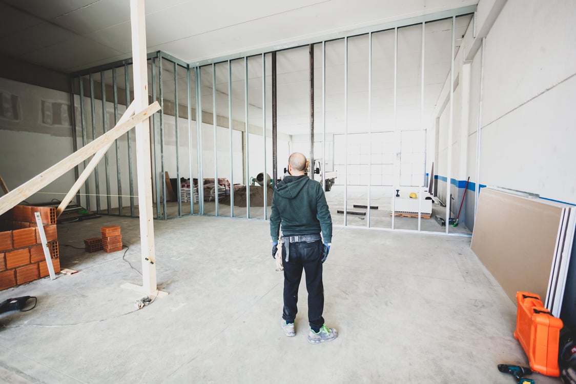 Worker Builds a Plasterboard Wall