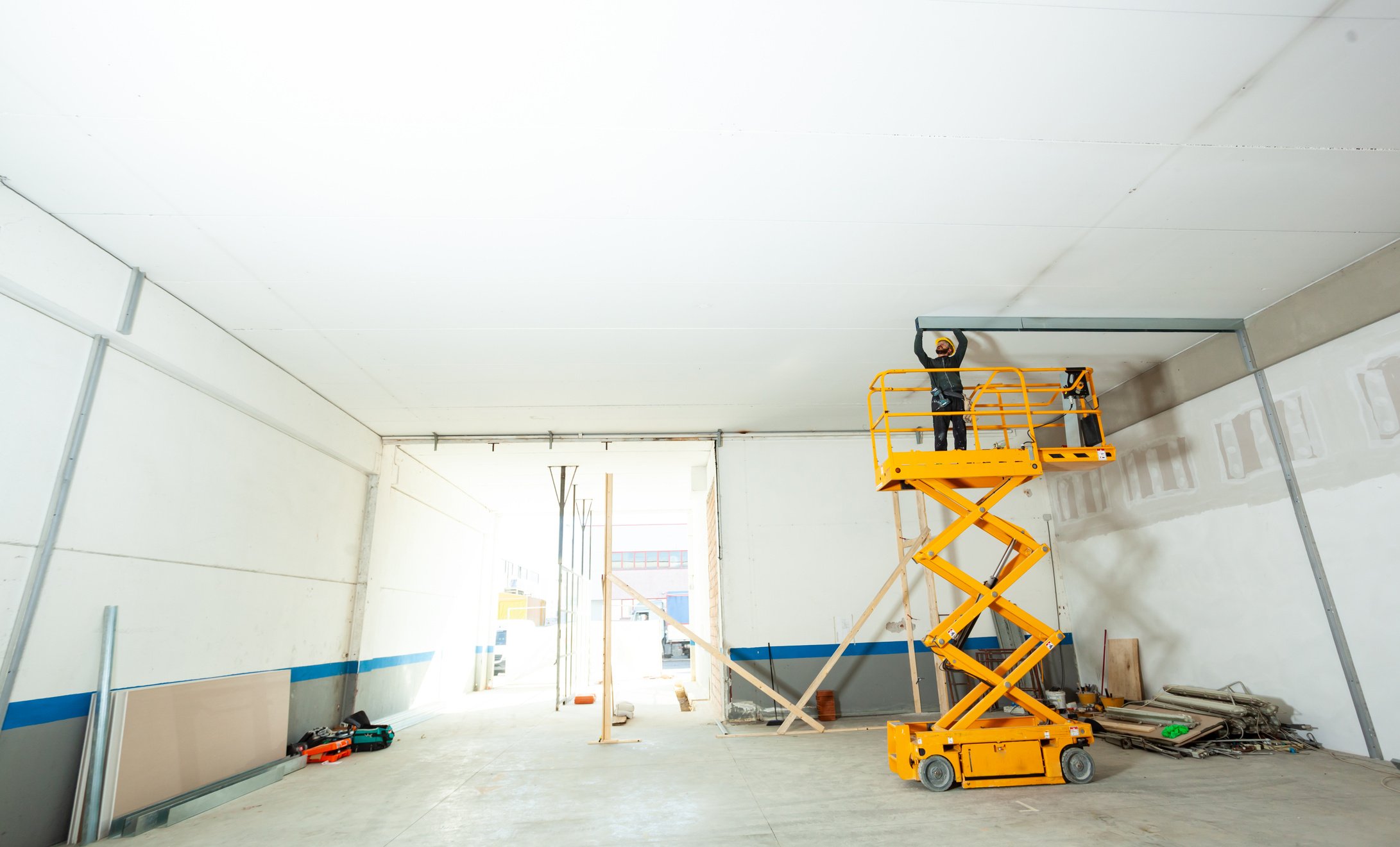 Worker Builds a Plasterboard Wall