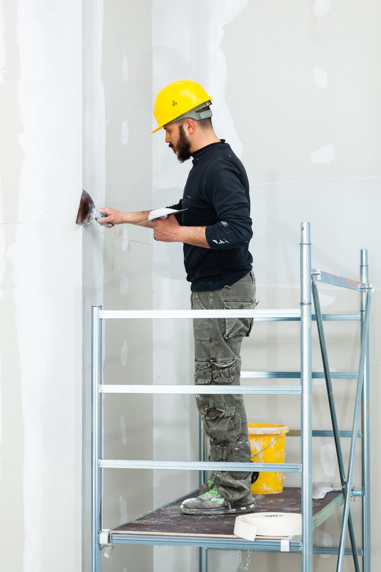 Worker Plastering Gypsum Board Wall